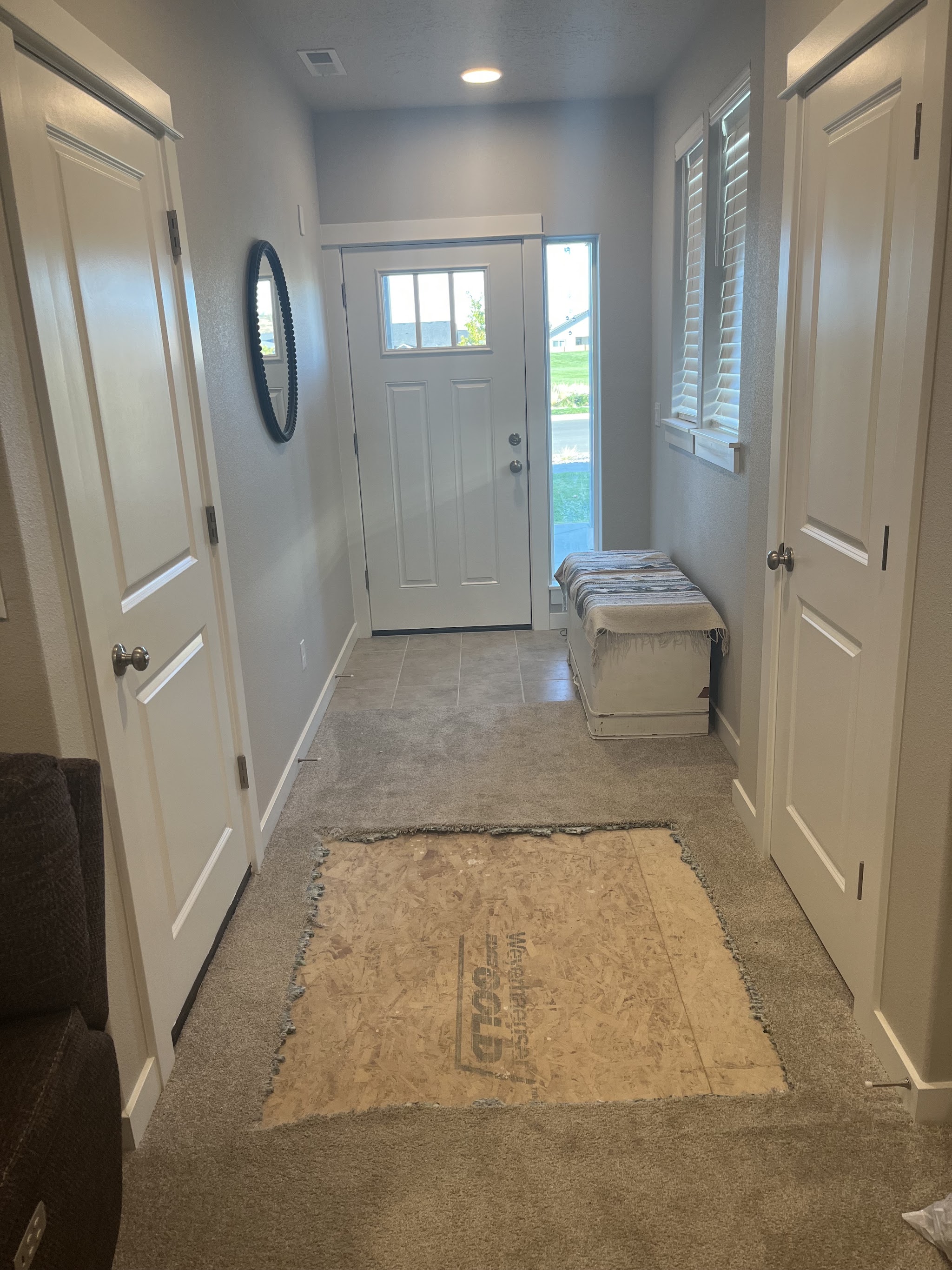 A hallway remodel nearing completion with new baseboard and trim