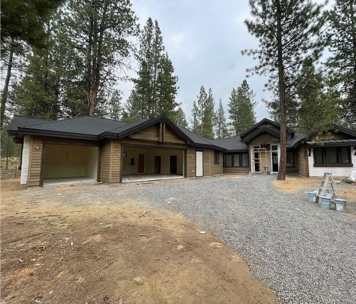 A new home under construction with framing and roofing complete