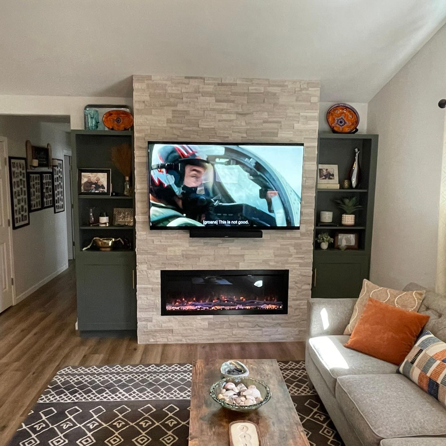 A living room fireplace and media wall remodel with built-in shelving